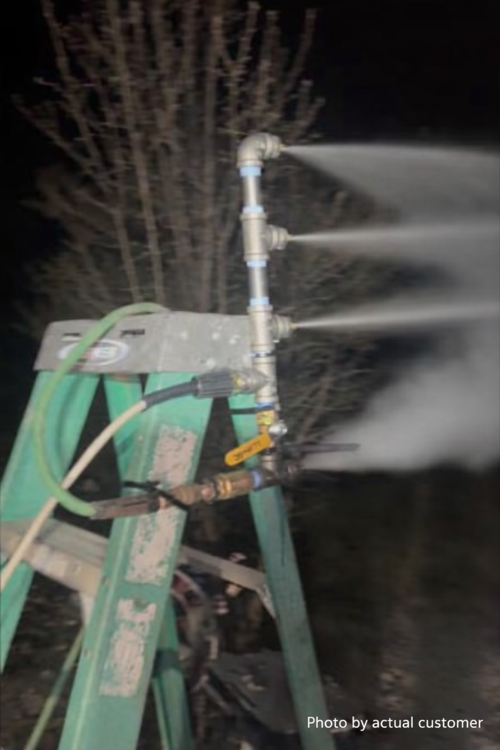 Garden snowmaker running at night with snow accumulating